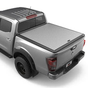 A silver aluminium tonneau cover fitted on a Nissan Navara NP300 pickup truck.